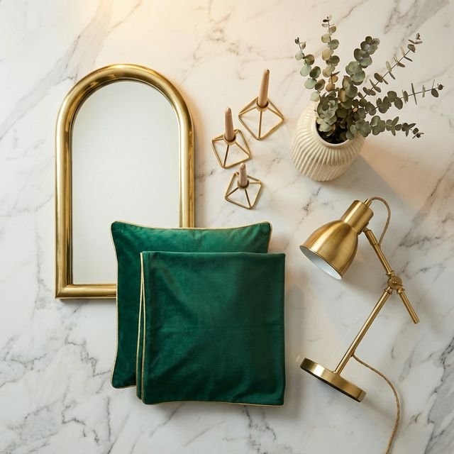 Neo Deco starter kit products including brass mirror and emerald pillows